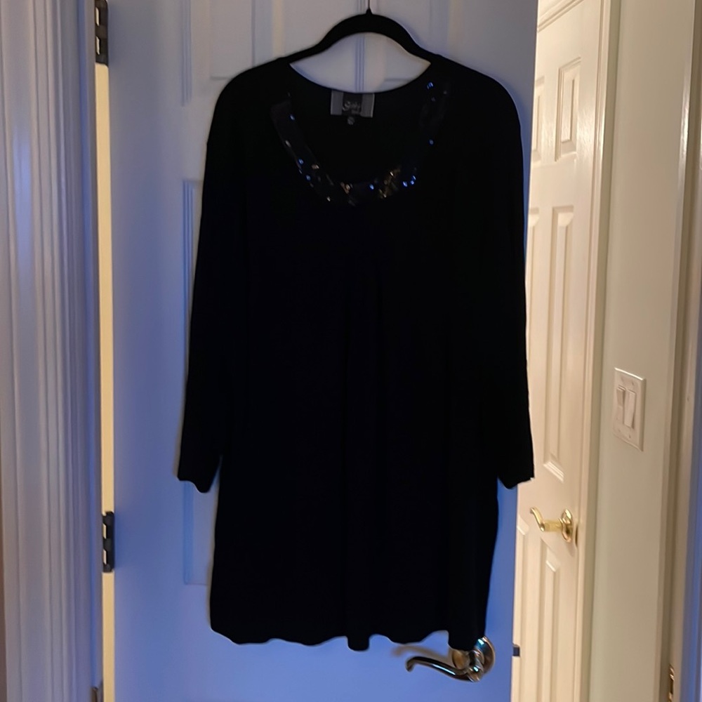 3x black top with sequined neckline with keyhole accent. 3/4 sleeves